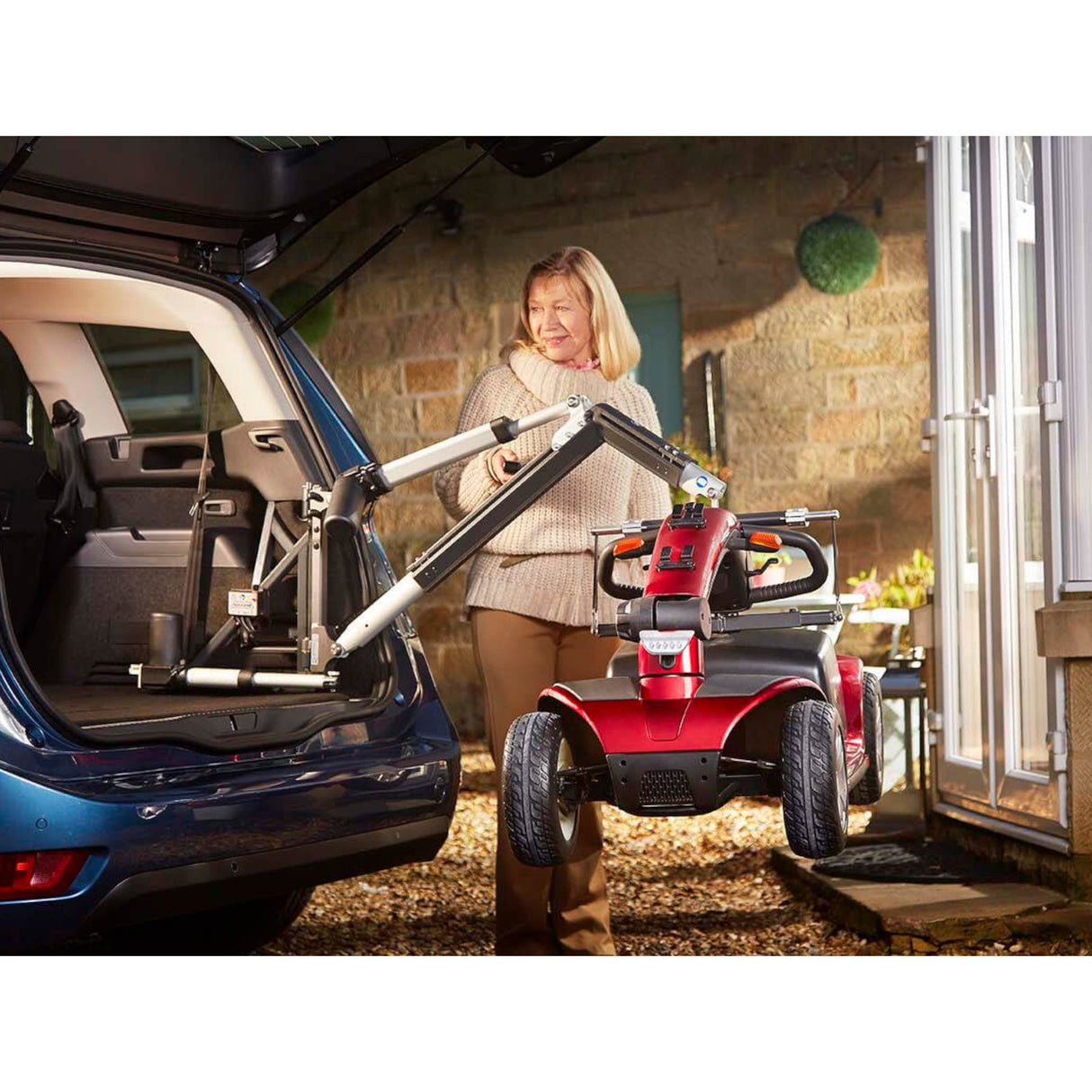 Smart lift moving a mobility scooter out of the trunk of the car