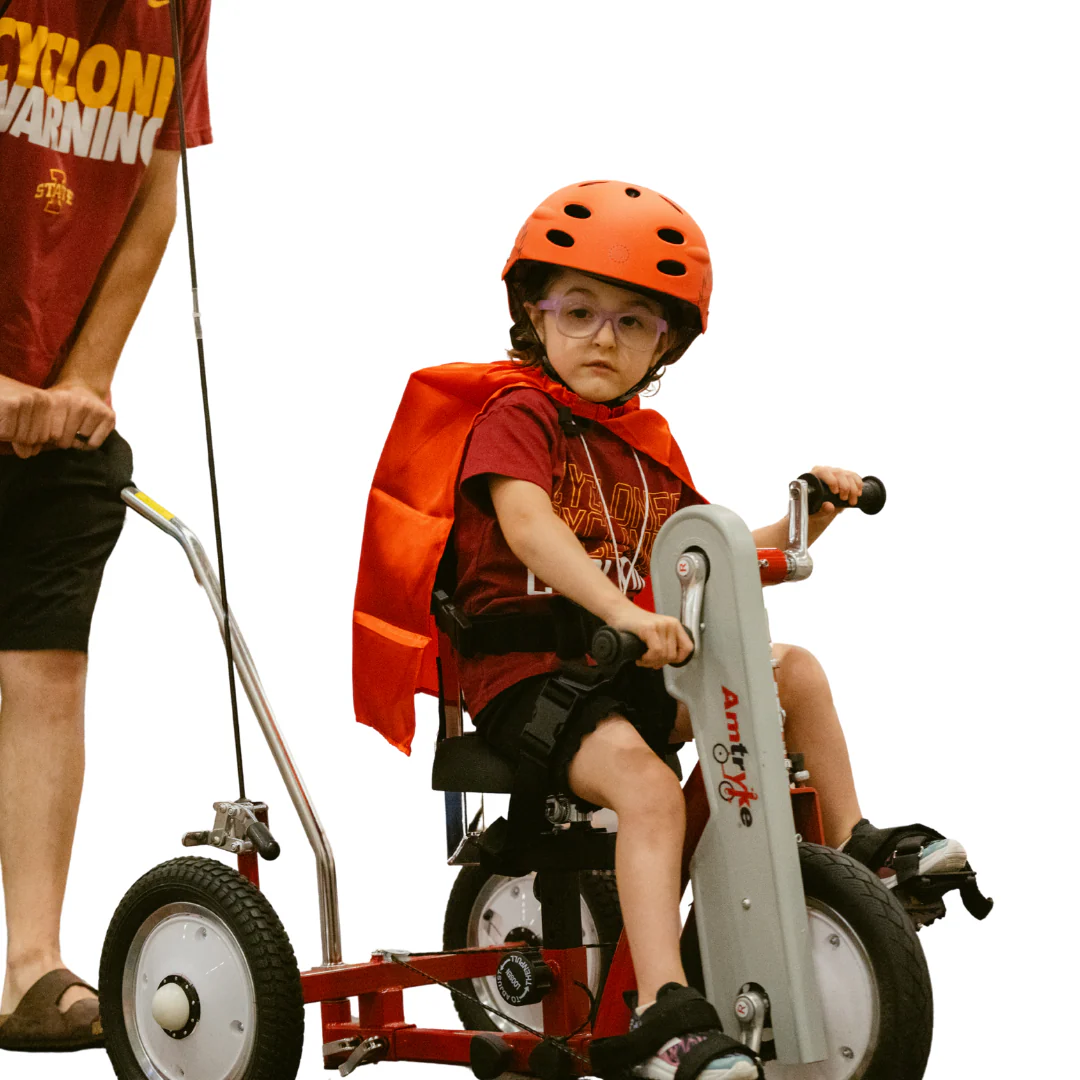 Child in helmet using Amtryke AM12S Adaptive Tricycle