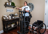 Woman in home using EasyStand Glider Large Standing Frame