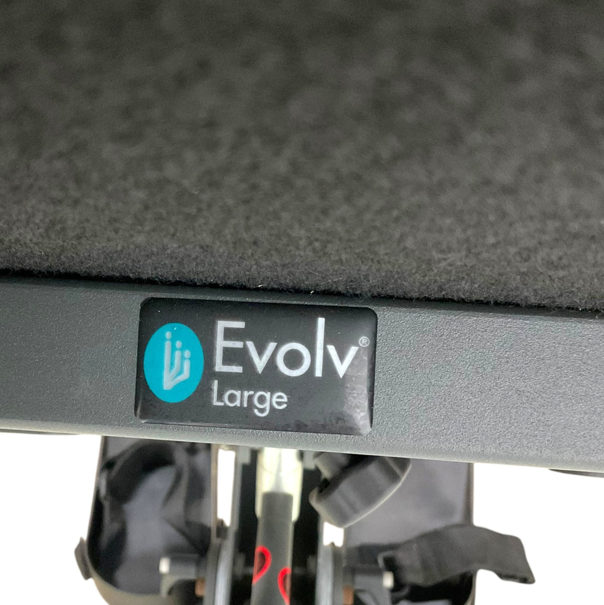 Close-up of a black Evolv Large wheelchair frame with a black textured cushion and the Evolv logo sticker on the side.