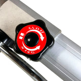 Close and open valve knob with red and white markings on a black star-shaped handle, attached to a silver metal pipe.