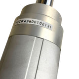 Close-up of a metallic cylindrical industrial component with a white label printed with the code QCB63600102131, on a plain white background.
