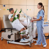 Nurse operating Liko Sabina II Electric Sit-to-Stand Patient Lift with patient